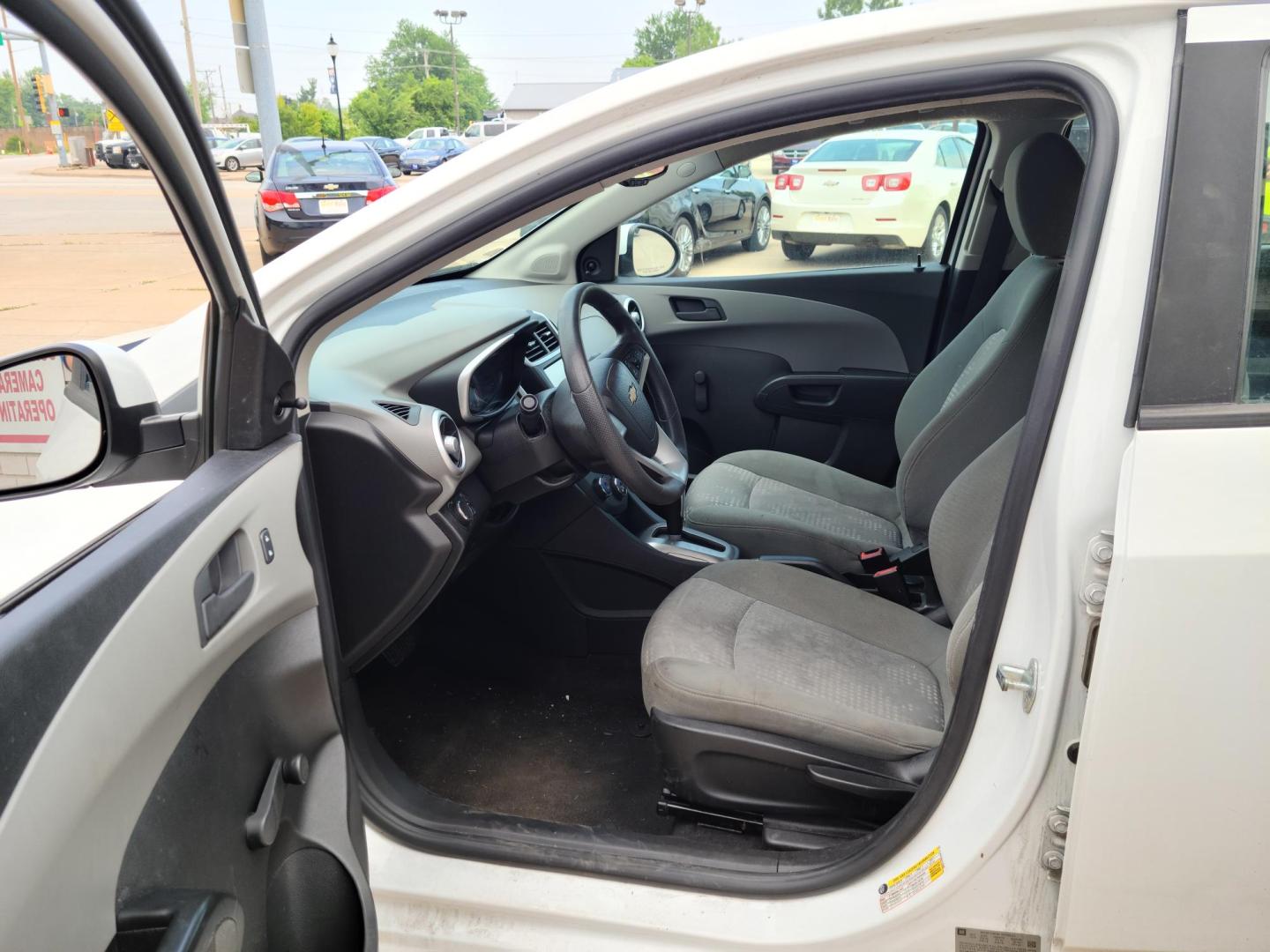 2017 Summit White /Jet Black/ Dark Titan Chevrolet Sonic LS Manual Sedan (1G1JB5SH6H4) with an 1.8L L4 DOHC 24V engine, 5M transmission, located at 104 1st Avenue, Silvis, IL, 61282, (309) 755-9511, 41.515156, -90.425377 - Photo#5