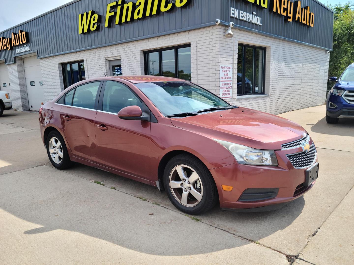 2012 Ruby Red Metallic Tinted Clearcoat /Black Chevrolet Cruze 1LT (1G1PF5SC4C7) with an 1.4L L4 DOHC 16V TURBO engine, 6-Speed Automatic transmission, located at 104 1st Avenue, Silvis, IL, 61282, (309) 755-9511, 41.515156, -90.425377 - Photo#0