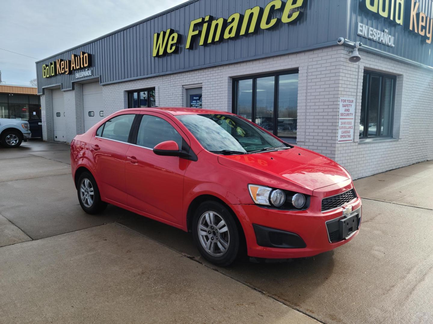 2015 Red Hot /Jet Black/ Brick Chevrolet Sonic LT Auto Sedan (1G1JC5SG3F4) with an 1.8L L4 DOHC 24V engine, 6-Speed Automatic transmission, located at 104 1st Avenue, Silvis, IL, 61282, (309) 755-9511, 41.515156, -90.425377 - Photo#0