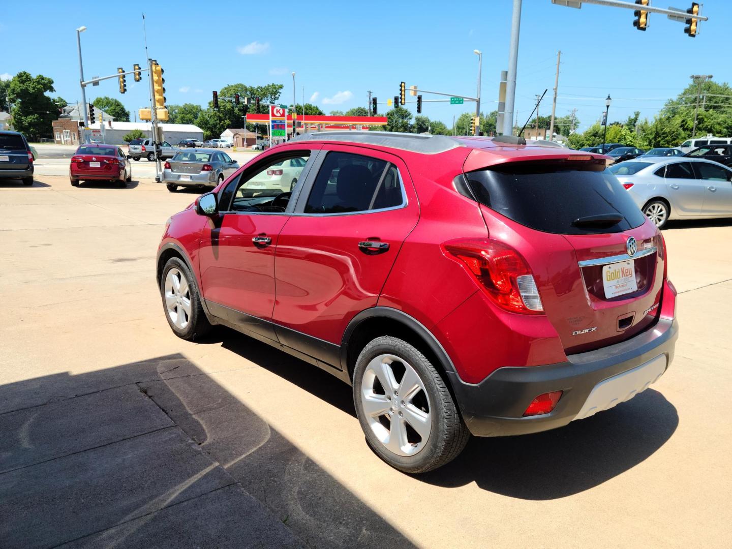 2015 Ruby Red Metallic Tinted Clearcoat /Black Buick Encore Convenience FWD (KL4CJBSB1FB) with an 1.4L L4 DOHC 16V TURBO engine, 6-Speed Automatic transmission, located at 104 1st Avenue, Silvis, IL, 61282, (309) 755-9511, 41.515156, -90.425377 - Photo#2