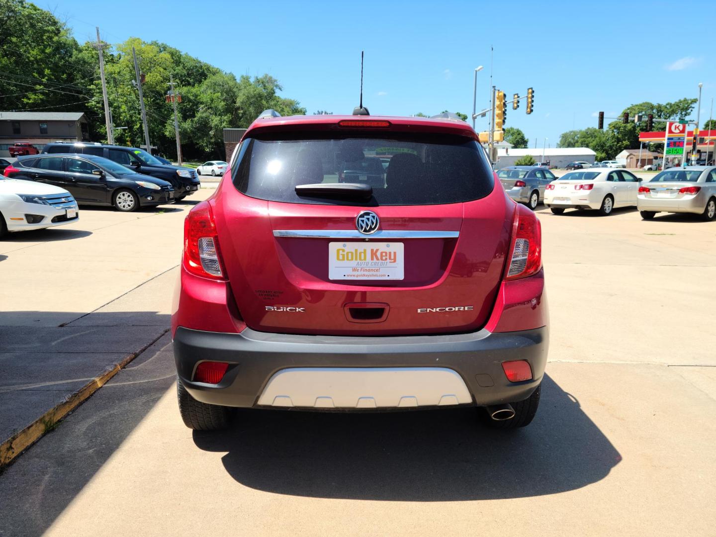 2015 Ruby Red Metallic Tinted Clearcoat /Black Buick Encore Convenience FWD (KL4CJBSB1FB) with an 1.4L L4 DOHC 16V TURBO engine, 6-Speed Automatic transmission, located at 104 1st Avenue, Silvis, IL, 61282, (309) 755-9511, 41.515156, -90.425377 - Photo#3