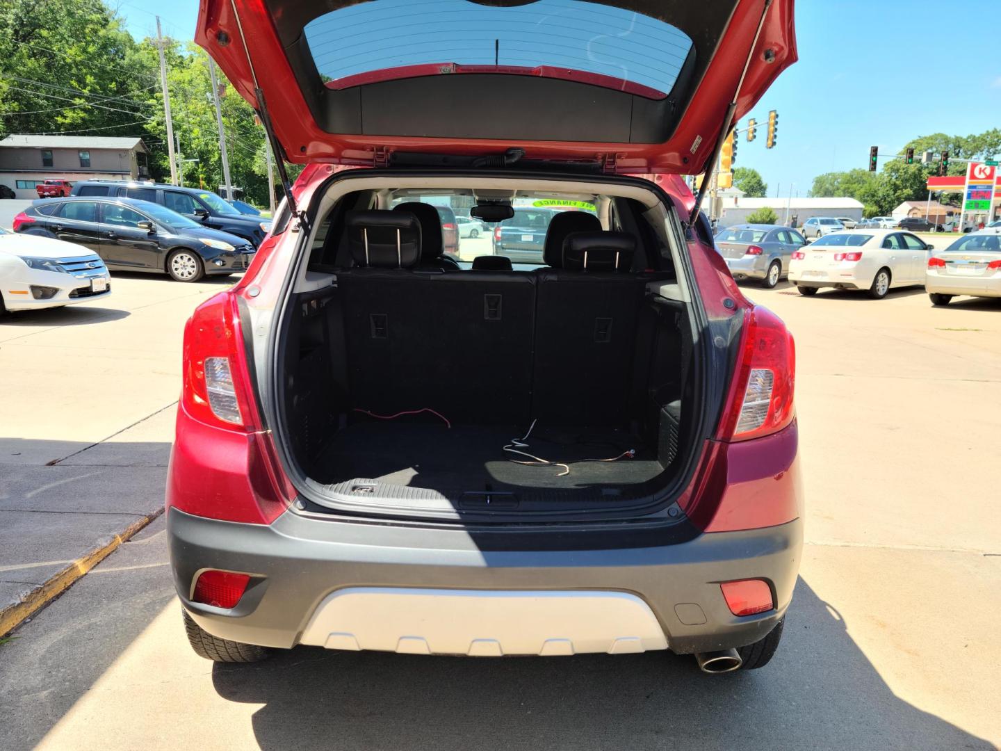 2015 Ruby Red Metallic Tinted Clearcoat /Black Buick Encore Convenience FWD (KL4CJBSB1FB) with an 1.4L L4 DOHC 16V TURBO engine, 6-Speed Automatic transmission, located at 104 1st Avenue, Silvis, IL, 61282, (309) 755-9511, 41.515156, -90.425377 - Photo#4