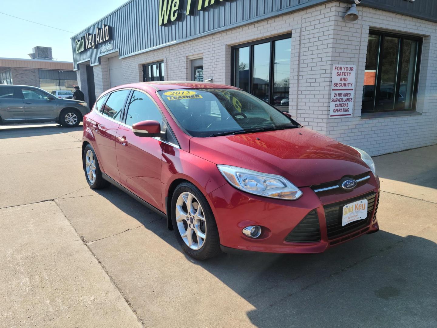 2012 Ruby Red Metallic Tinted Clearcoat /Black Ford Focus SEL (1FAHP3M24CL) with an 2.0L L4 DOHC 16V engine, 6-Speed Automatic transmission, located at 104 1st Avenue, Silvis, IL, 61282, (309) 755-9511, 41.515156, -90.425377 - Photo#1