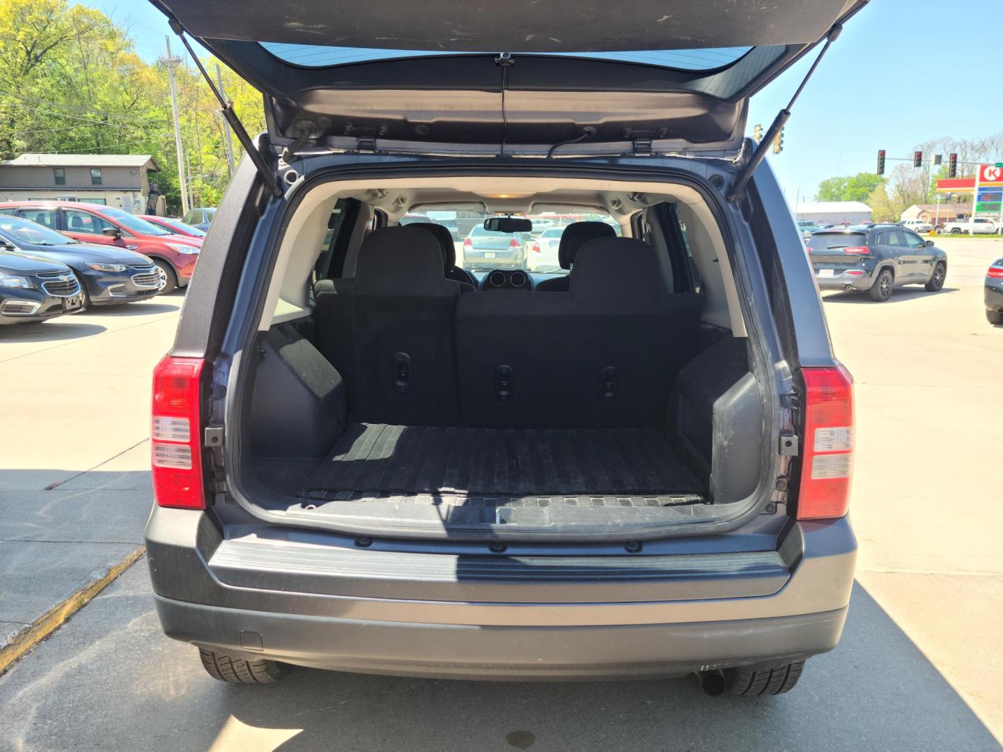 2015 Gray Jeep Patriot Latitude 4WD (1C4NJRFB2FD) with an 2.4L L4 DOHC 16V engine, Auto transmission, located at 104 1st Avenue, Silvis, IL, 61282, (309) 755-9511, 41.515156, -90.425377 - Photo#3