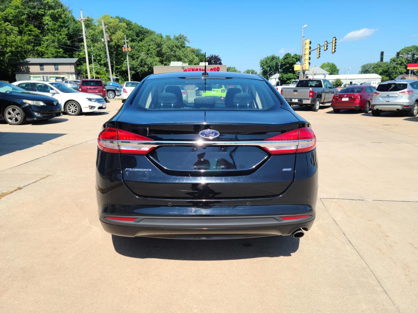 2017 Carbon Black Metallic /Black Ford Fusion SE (3FA6P0H70HR) with an 2.5L L4 DOHC 16V engine, 6A transmission, located at 104 1st Avenue, Silvis, IL, 61282, (309) 755-9511, 41.515156, -90.425377 - Photo#2
